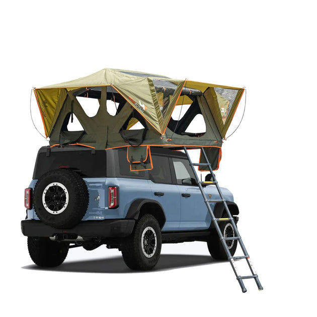 Dark green family camping tent with spacious interior and integrated mattress setup in natural outdoor setting