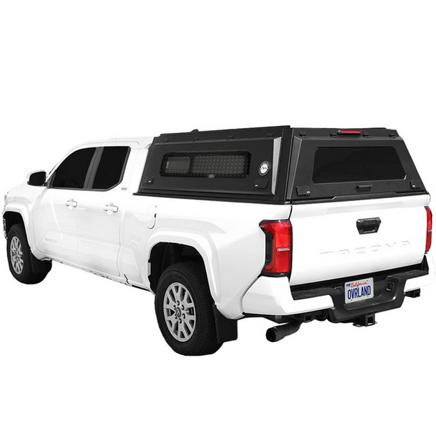 Overland Vehicle Systems Expedition Pro+ truck cap installed on pickup truck with full windows and wing doors