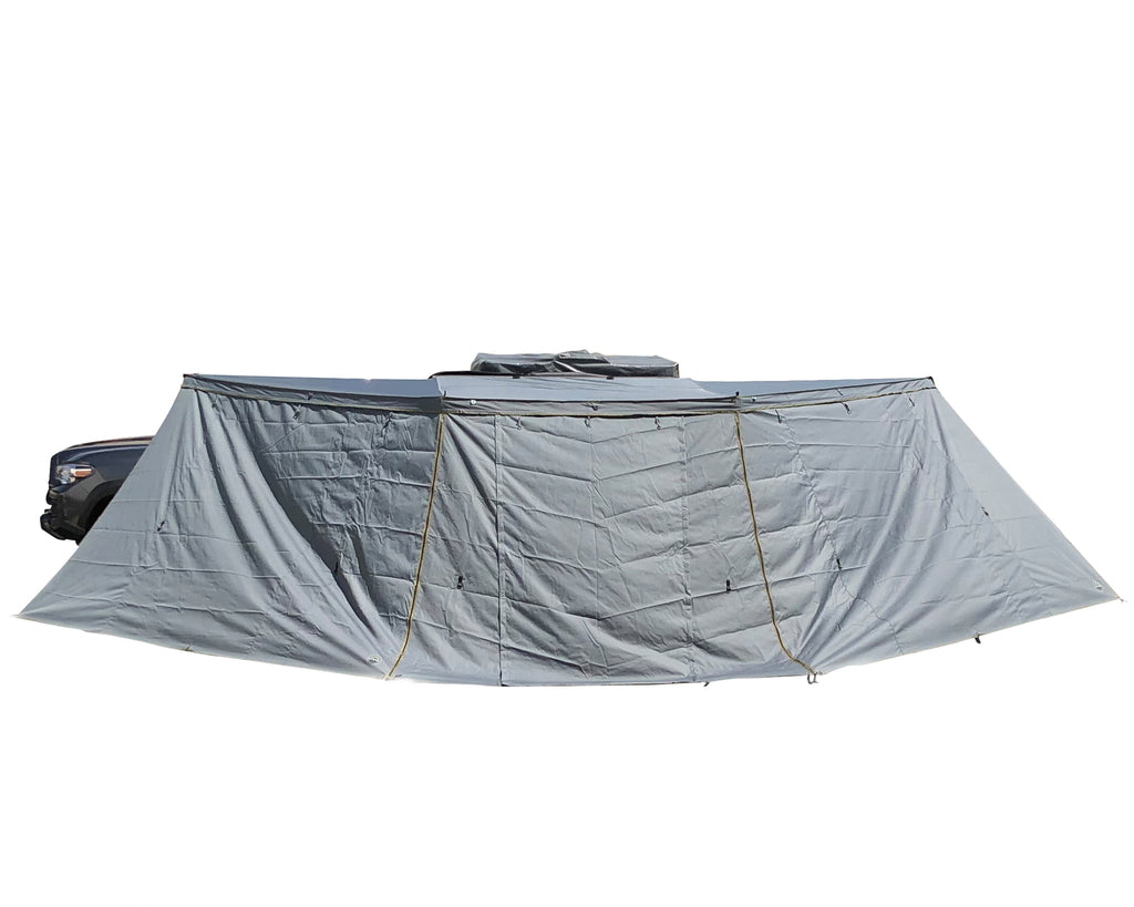 Overland Vehicle Systems Nomadic Awning Side Wall attached to vehicle awning creating enclosed shelter space