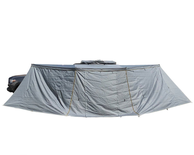 Overland Vehicle Systems Nomadic Awning Side Wall attached to vehicle awning creating enclosed shelter space