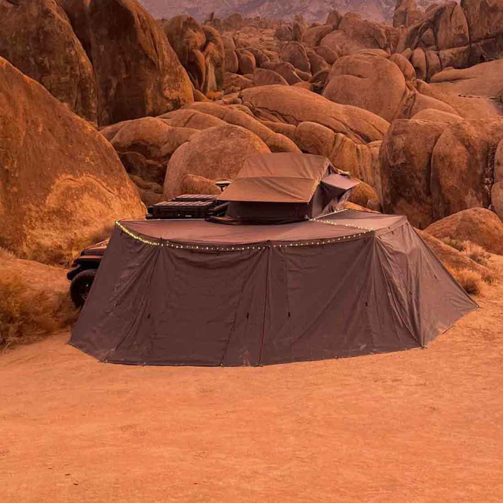 Overland Vehicle Systems Nomadic Awning Wall Kit attached to vehicle showing three-panel enclosure system