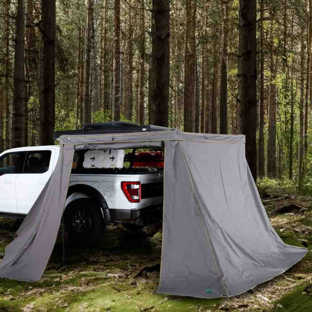 Overland Vehicle Systems Nomadic 270LT awning wall kit attached to vehicle creating enclosed outdoor shelter with multiple pa