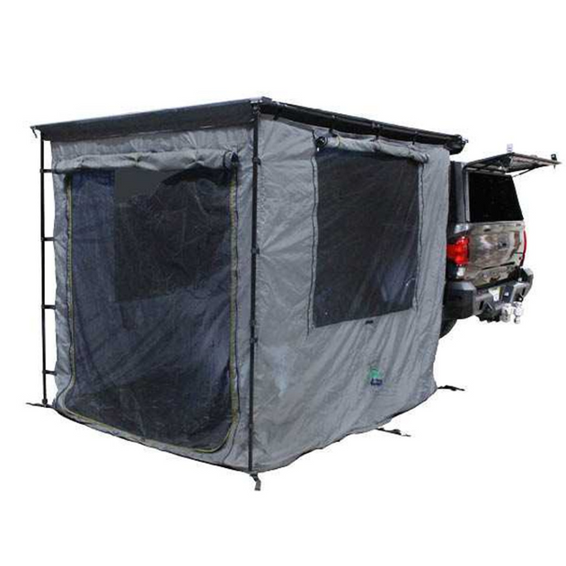 Overland Vehicle Systems Nomadic Awning Room enclosure with grey body and green trim attached to vehicle awning