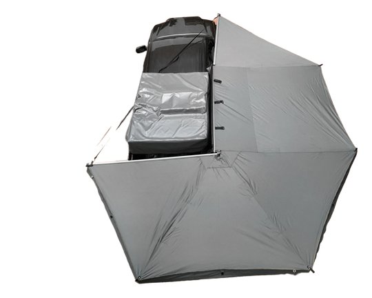 Overland Vehicle Systems 270-degree awning extended from side of van creating large shaded shelter area
