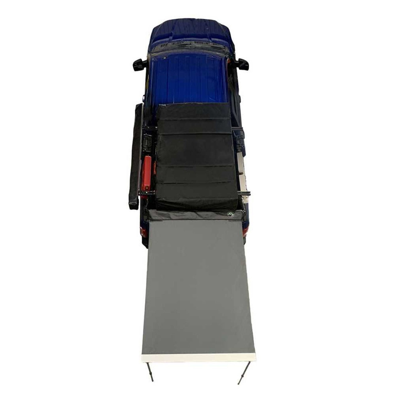 Overland Vehicle Systems Nomadic 4.5-foot awning deployed on vehicle providing shade and rain protection