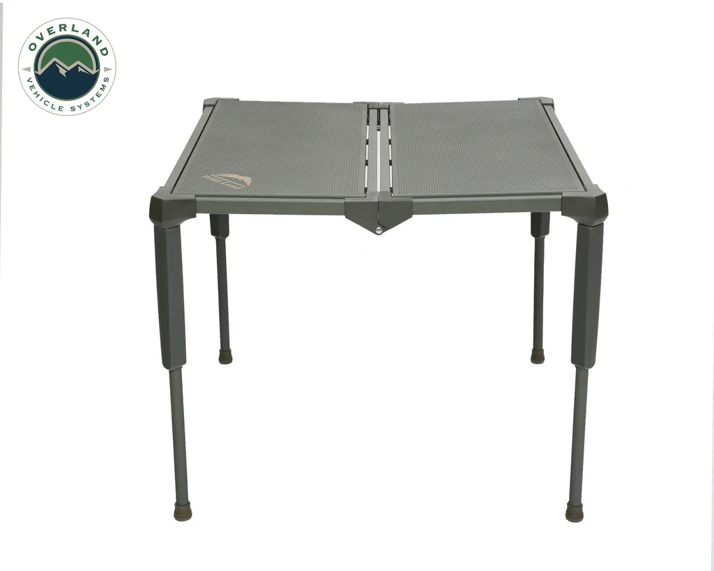 Overland Vehicle Systems large camping table set up in outdoor setting with camping gear on surface