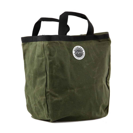Overland Vehicle Systems waxed canvas tote bag with leather handles and metal hardware, shown in rugged outdoor setting