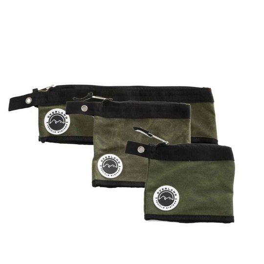 Three waxed canvas storage bags from Overland Vehicle Systems showing durable construction and organization features