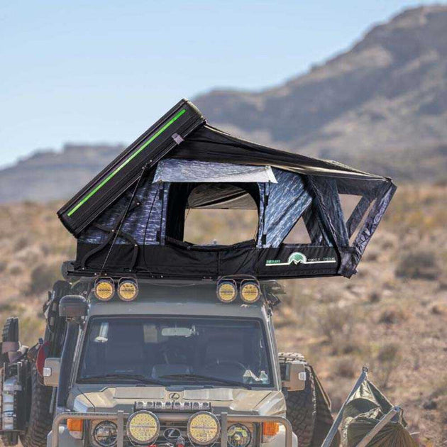 Overland Vehicle Systems Everest cantilever roof top tent mounted on vehicle with ladder extended