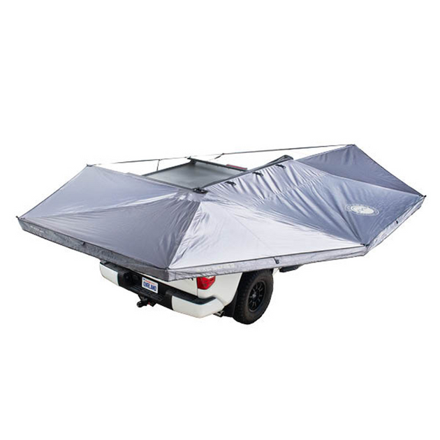 Overland Vehicle Systems Nomadic 270-degree awning deployed with LED lights illuminating the sheltered area