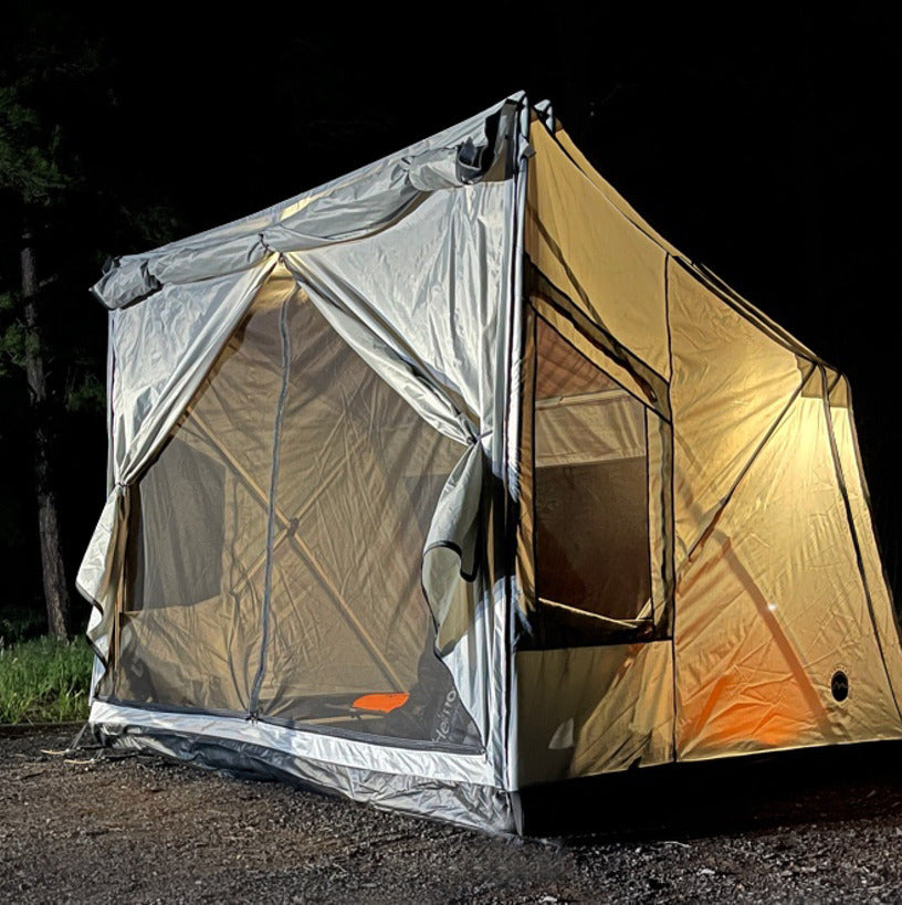 Overland Vehicle Systems Safari Tent deployed in outdoor setting with family camping gear
