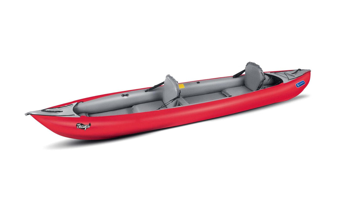Red inflatable kayak with gray seats on a white background