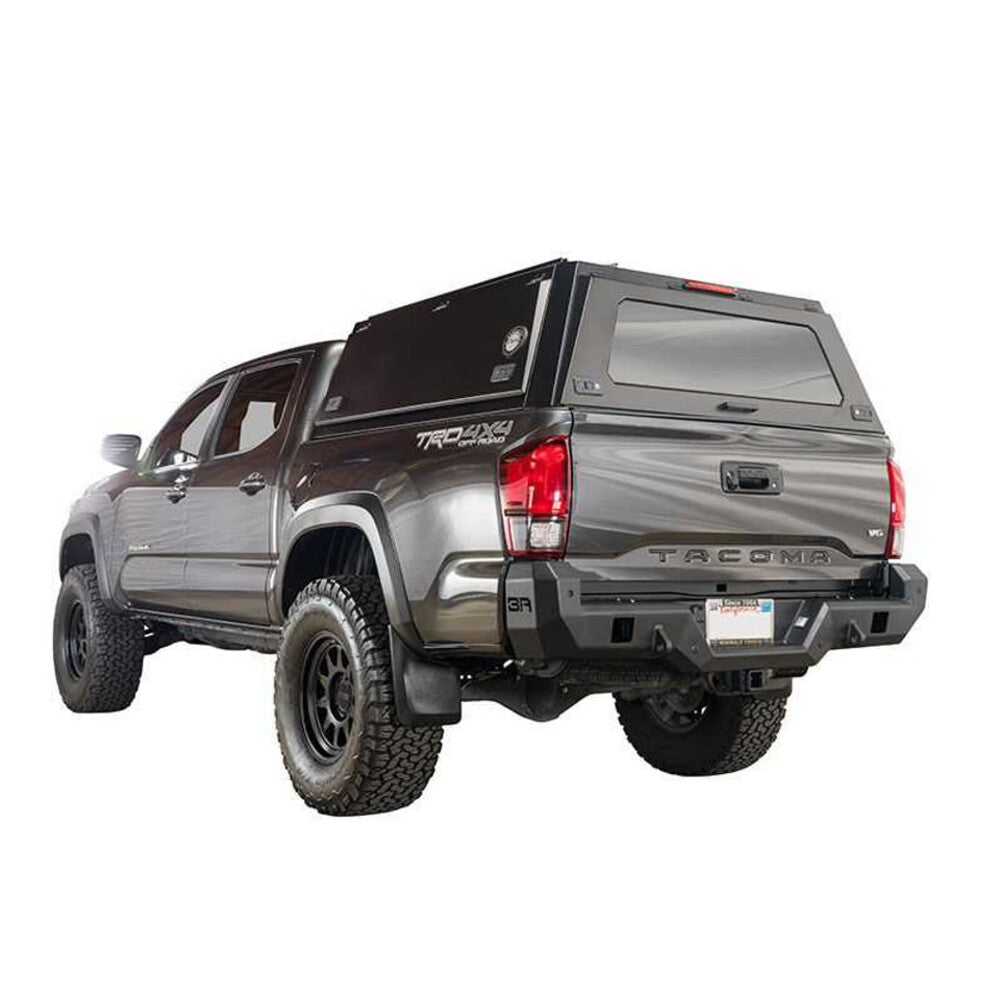 Overland Vehicle Systems Expedition Truck Cap with full wing doors open showing spacious truck bed storage area