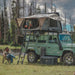 Overland Vehicle Systems Bushveld hard shell roof top tent mounted on vehicle rooftop with ladder extended