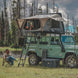 Overland Vehicle Systems Bushveld hard shell roof top tent mounted on vehicle rooftop with ladder extended