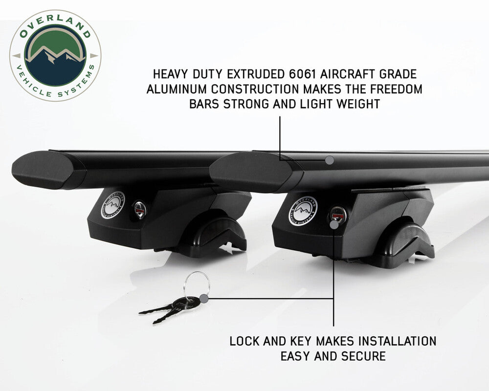 Overland Vehicle Systems Freedom Cross Bars mounted on vehicle roof rails with adventure gear attachment points