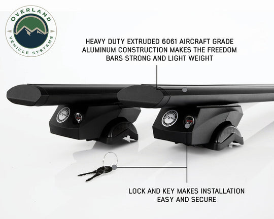 Overland Vehicle Systems Freedom Cross Bars mounted on vehicle roof rails with adventure gear attachment points