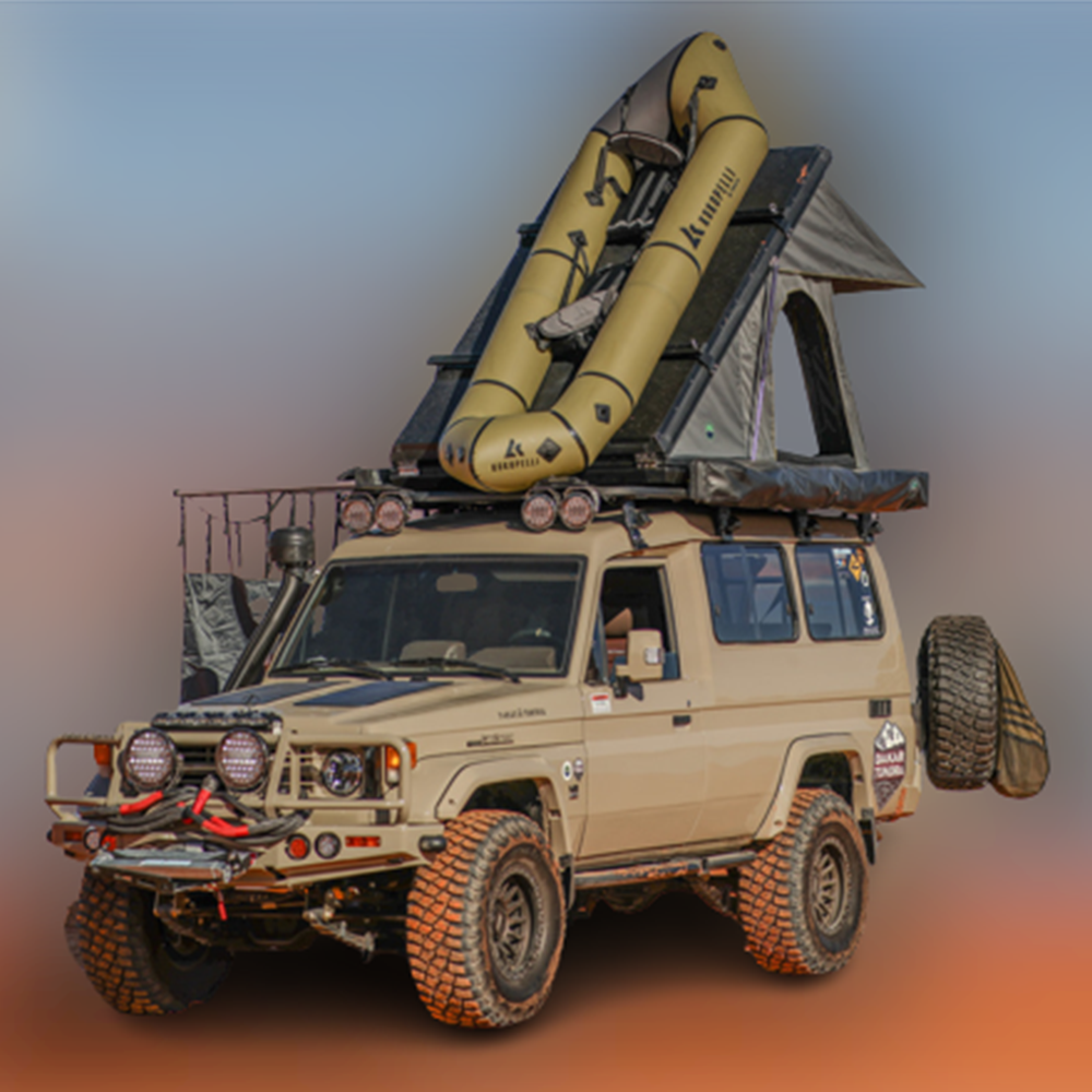 OVS Mamba hard shell rooftop tent mounted on vehicle roof with ladder extended, showing compact closed position