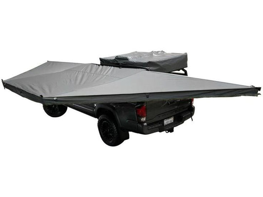 Overland Vehicle Systems Nomadic 180 Awning deployed on vehicle providing large shaded outdoor living space
