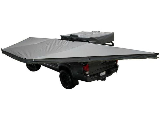 Overland Vehicle Systems Nomadic 180 Awning deployed on vehicle providing large shaded outdoor living space